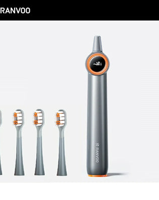 Two electric toothbrushes with gray bodies and orange detailing. One has a blue brush head and the other has a white brush head.