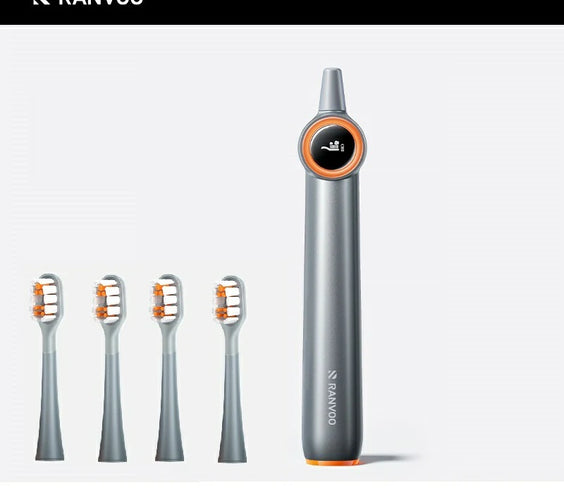 Two electric toothbrushes with gray bodies and orange detailing. One has a blue brush head and the other has a white brush head.